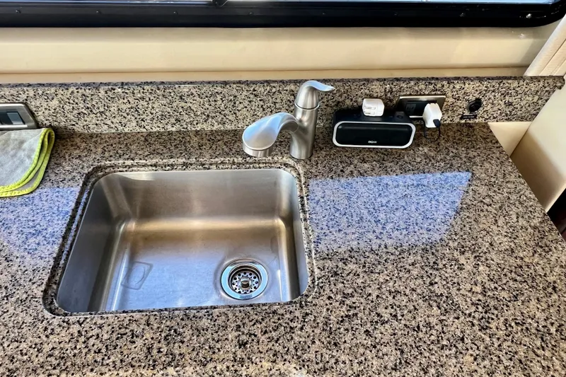 Slide: The Image of Granite countertop with sink in 2007 Sea Ray 58 Sedan Bridge yacht kitchen. - 91