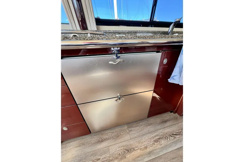 Slide: The Image of 2007 Sea Ray 58 Sedan Bridge yacht kitchen with stainless steel appliances and wood flooring. - 94