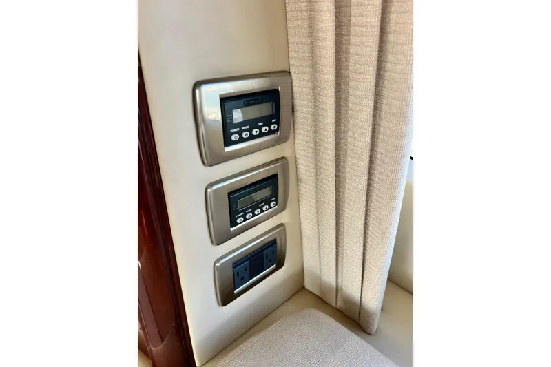 Slide: The Image of Control panel and outlets on 2007 Sea Ray 58 Sedan Bridge yacht interior. - 97