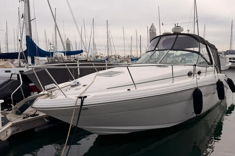 The Image of 2005 Sea Ray 300 Sundancer docked at marina with sailboats in background. - 0