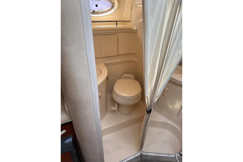 Slide: The Image of Bathroom interior of 2005 Sea Ray Sundancer 280 boat, featuring toilet and shower area. - 14