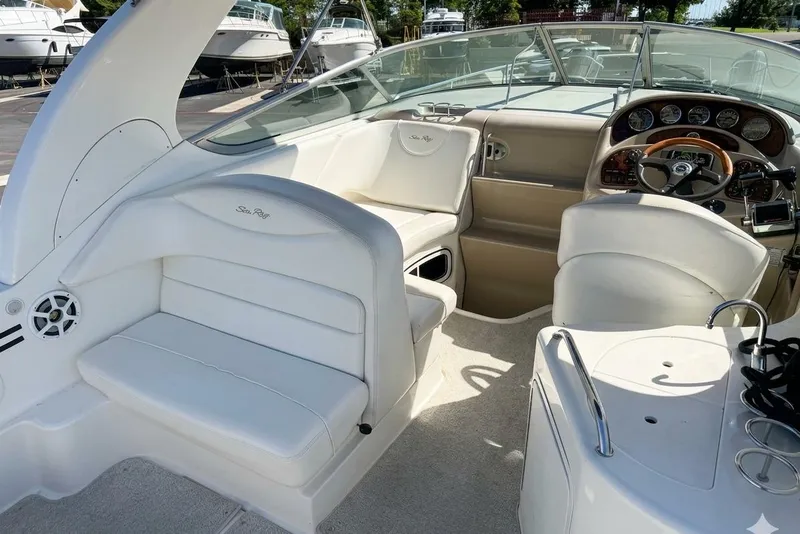 Slide: The Image of 2005 Sea Ray Sundancer 280 boat interior with white seating and control panel. - 5