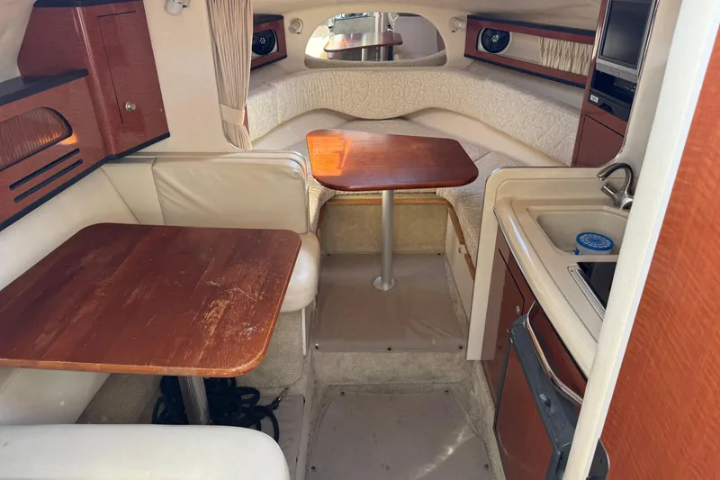 Slide: The Image of Interior of 2005 Sea Ray Sundancer 280, featuring dining area and kitchenette. - 8