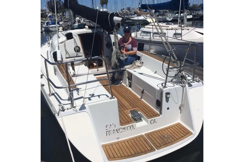 Slide: The Image of 1986 Farr 1020 sailboat docked in San Francisco marina with person handling ropes. - 8