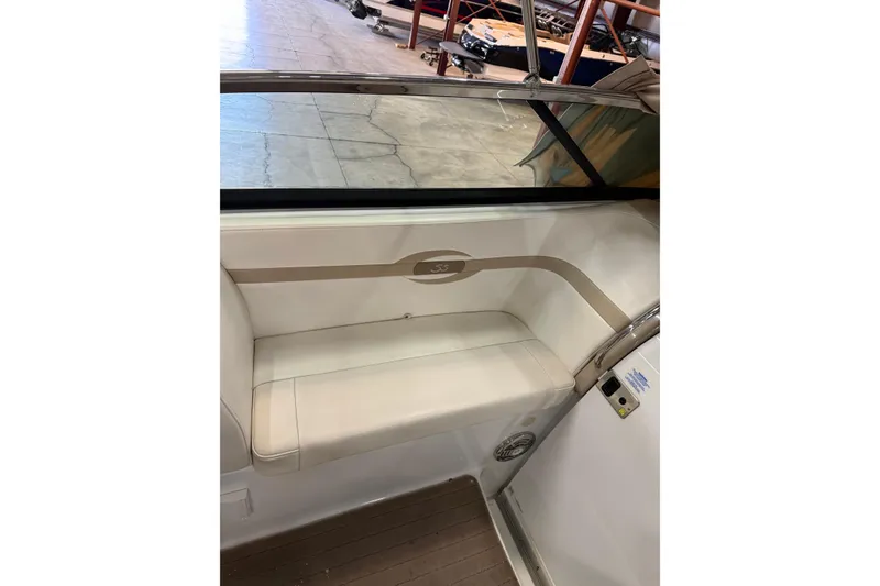 Slide: The Image of Interior seating of a 2009 Formula 310 Sun Sport boat, featuring beige upholstery. - 12