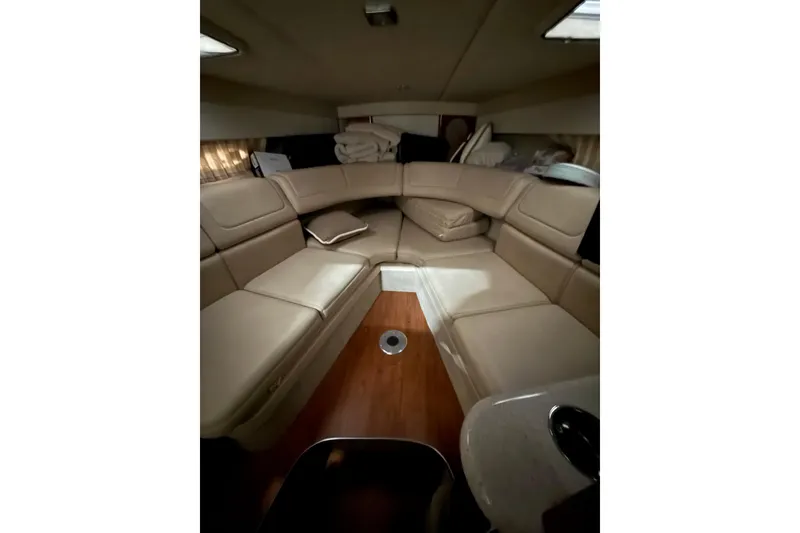 Slide: The Image of Interior of 2009 Formula 310 Sun Sport boat with beige seating and wooden flooring. - 13