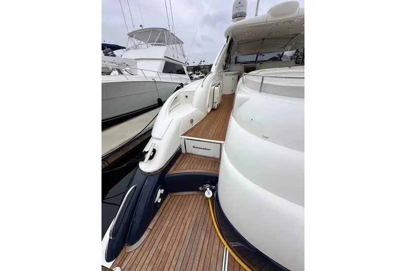 Slide: The Image of Luxury Sunseeker Predator 60 yacht, 2000 model, docked with sleek design and wooden deck. - 12