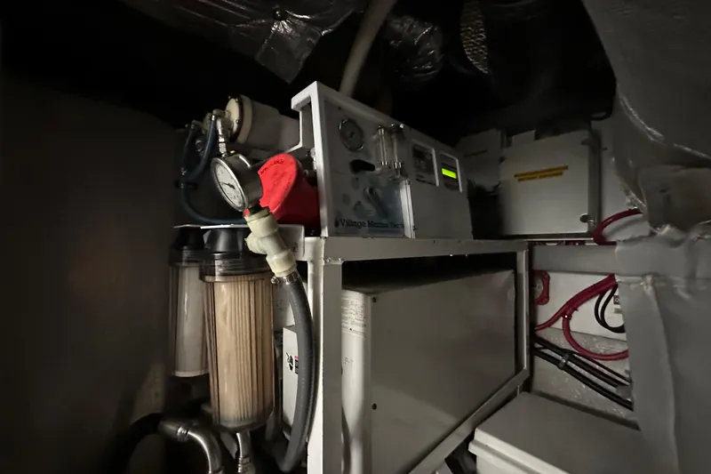 Slide: The Image of Engine room of 2000 Sunseeker Predator 60 yacht, featuring mechanical equipment and gauges. - 120