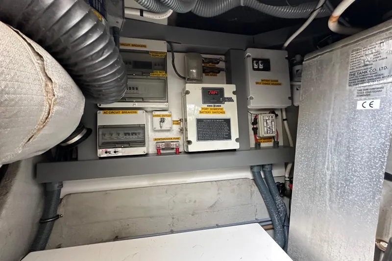 Slide: The Image of Electrical panel inside a 2000 Sunseeker Predator 60 yacht, featuring circuit breakers and battery switches. - 127
