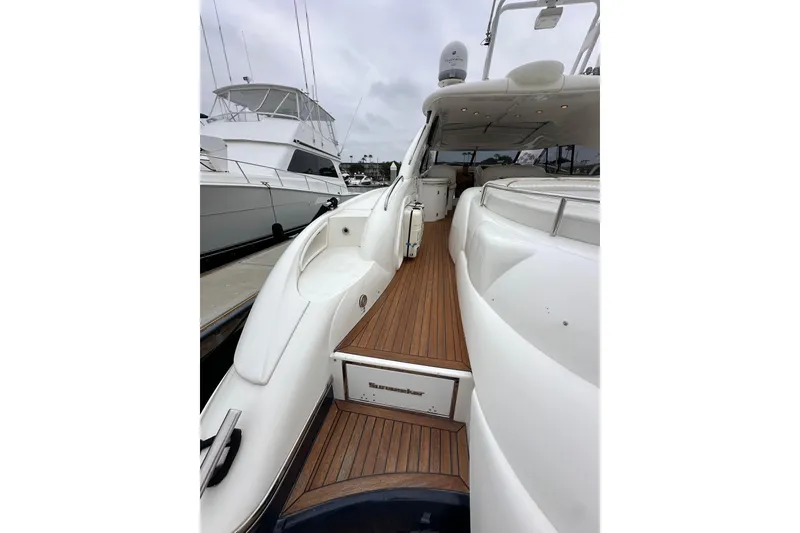 Slide: The Image of Sunseeker Predator 60 yacht, 2000 model, featuring sleek white design and wooden deck. - 13