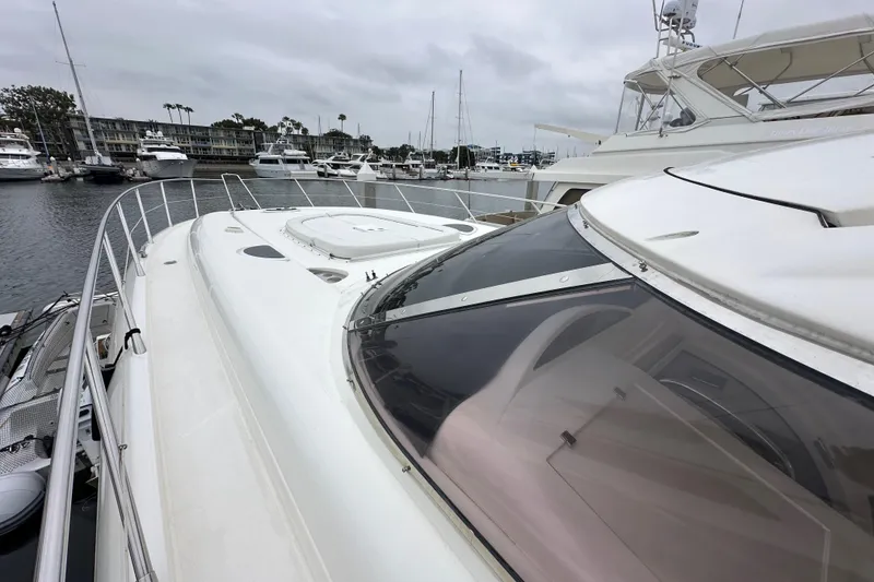 Slide: The Image of Sunseeker Predator 60 yacht, 2000 model, docked in a marina with overcast skies. - 18