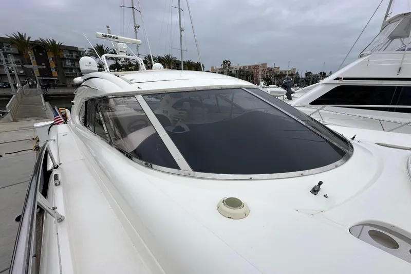Slide: The Image of Sunseeker Predator 60 yacht, 2000 model, docked at marina under cloudy skies. - 26