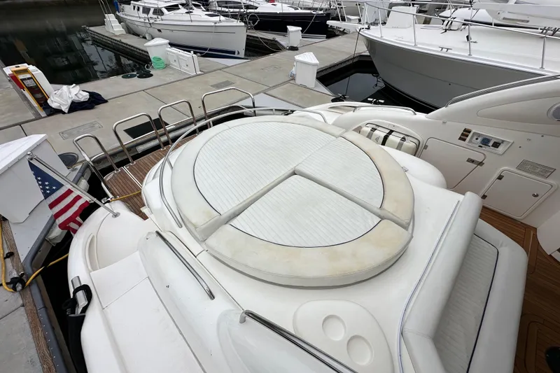 Slide: The Image of Sunseeker Predator 60 yacht, 2000 model, docked with American flag, featuring spacious deck area. - 30