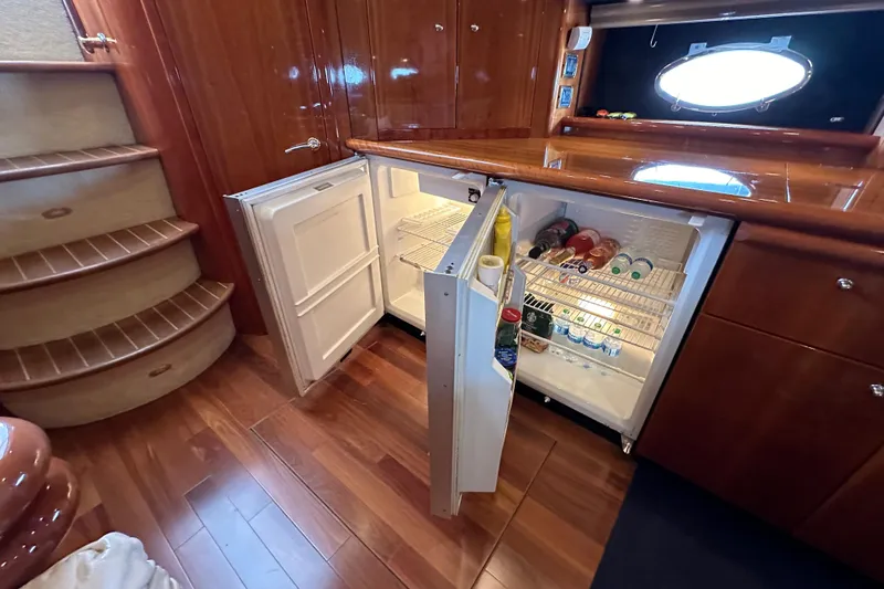 Slide: The Image of Sunseeker Predator 60 yacht interior with open fridge, wooden flooring, and stairs, 2000 model. - 81