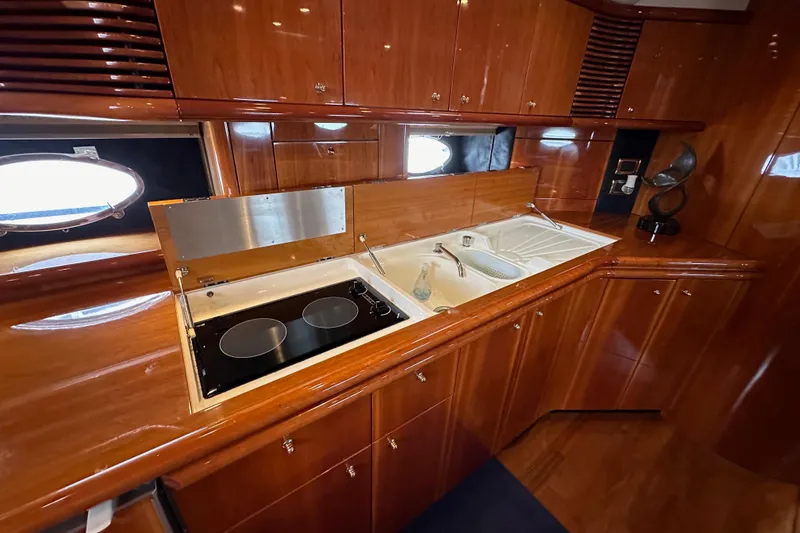 Slide: The Image of Luxurious kitchen interior of 2000 Sunseeker Predator 60 yacht with wooden cabinetry. - 85