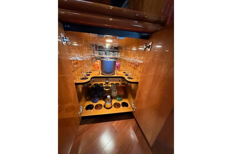 Slide: The Image of Luxurious wooden cabinet with glassware and accessories on Sunseeker Predator 60 yacht, 2000 model. - 88