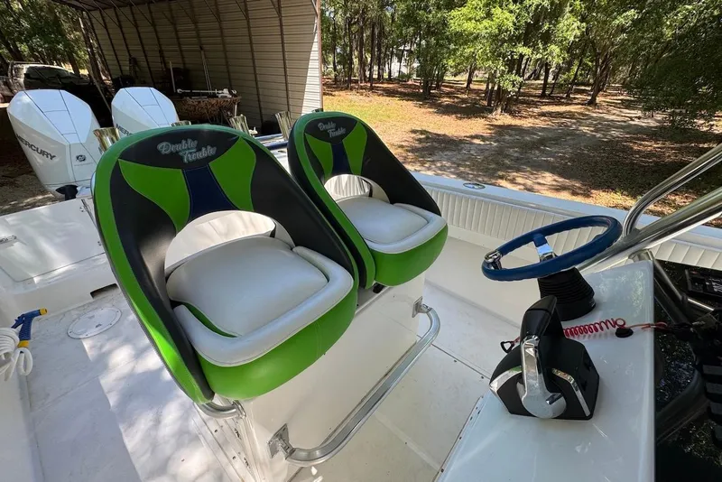 Slide: The Image of 2000 Fountain 31 Tournament Edition boat with green and black seats, dual Mercury engines. - 10