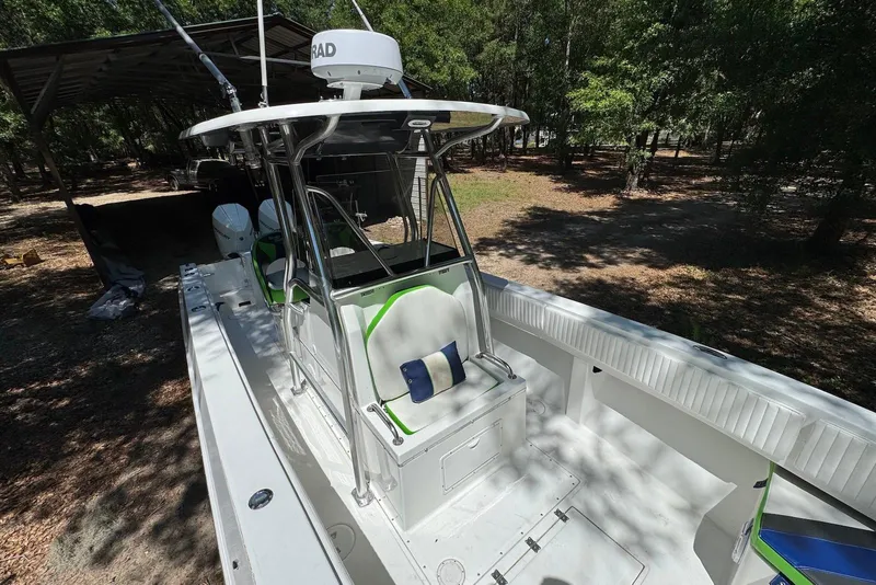 Slide: The Image of 2000 Fountain 31 Tournament Edition boat with T-top, parked outdoors in wooded area. - 13