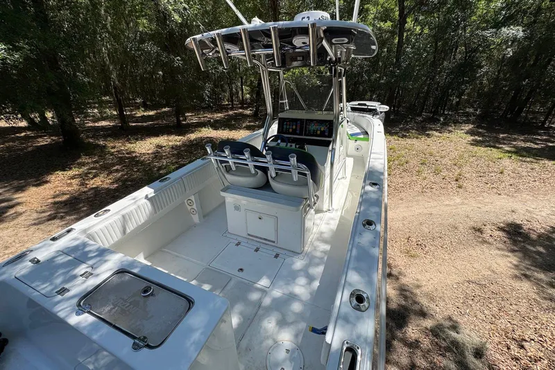 Slide: The Image of 2000 Fountain 31 Tournament Edition boat with spacious deck in wooded area. - 14