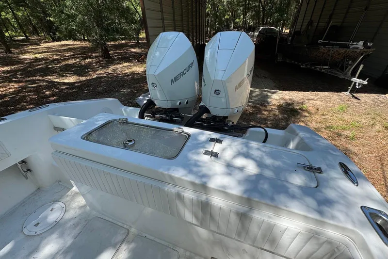 Slide: The Image of 2000 Fountain 31 Tournament Edition boat with dual Mercury outboard engines in a wooded area. - 15