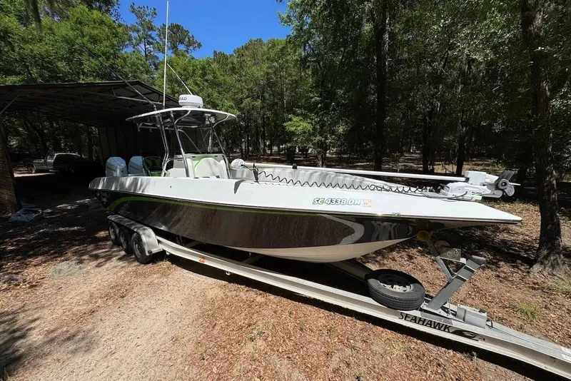 Slide: The Image of 2000 Fountain 31 Tournament Edition boat on trailer in wooded area. - 3