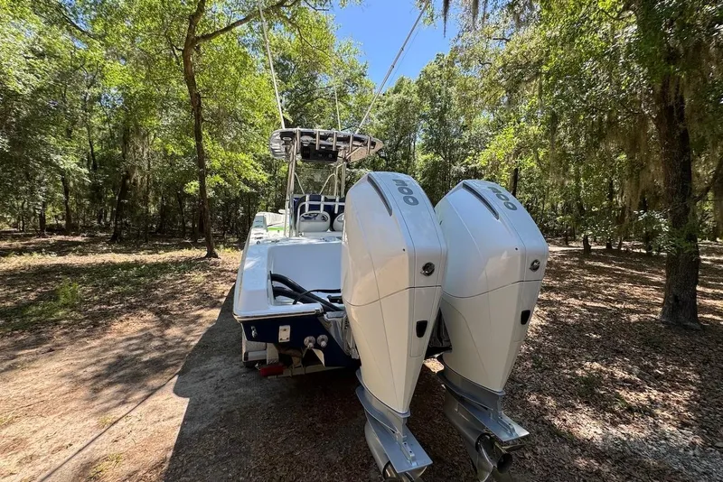 Slide: The Image of 2000 Fountain 31 Tournament Edition boat with dual outboard motors in a wooded area. - 7