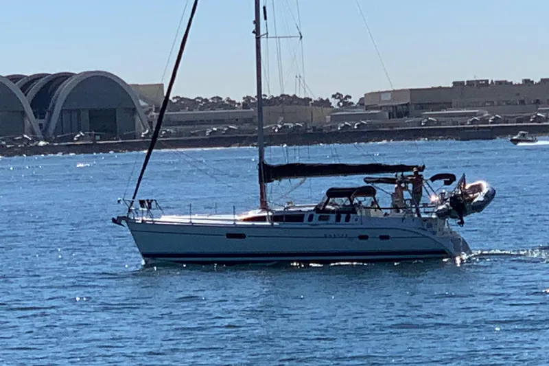 Slide: The Image of Sailboat on water, 2002 Hunter 410 model, near modern waterfront buildings. - 1