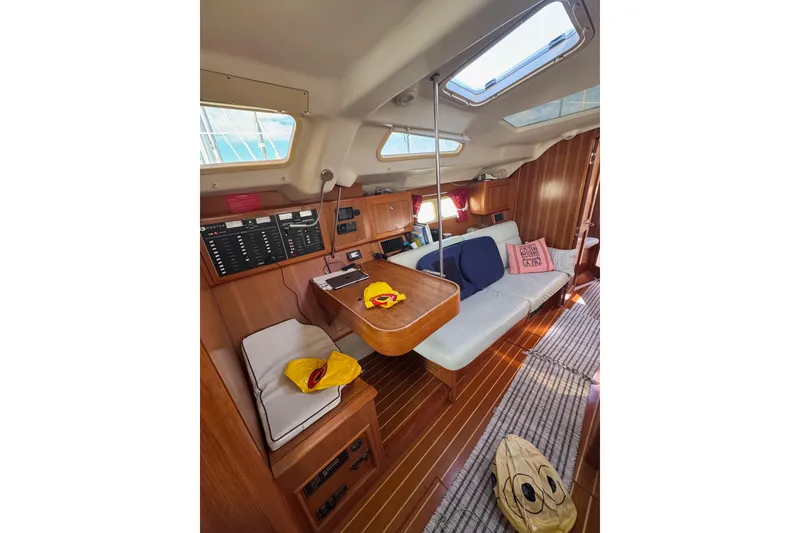 Slide: The Image of Interior of 2002 Hunter 410 sailboat with cozy seating and navigation panel. - 7