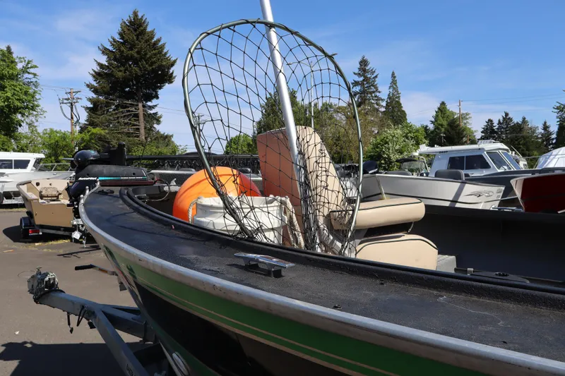 Slide: The Image of 1997 Willie Boats Predator with fishing net, parked outdoors on a sunny day. - 10