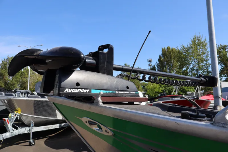 Slide: The Image of 1997 Willie Boats Predator with AutoPilot trolling motor, parked outdoors. - 11