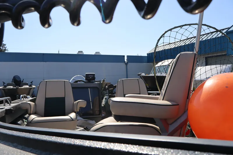 Slide: The Image of 1997 Willie Boats Predator interior with seating and equipment, featuring a bright orange buoy. - 13