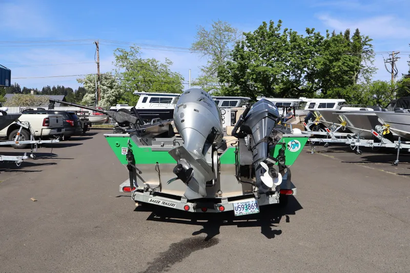 Slide: The Image of 1997 Willie Boats Predator with dual outboard motors on a trailer in a parking lot. - 3