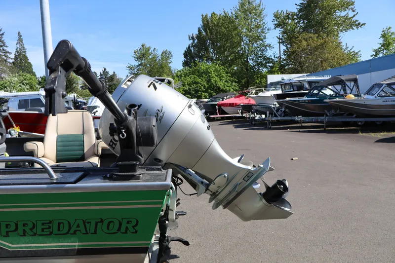 Slide: The Image of 1997 Willie Boats Predator with outboard motor in a boatyard setting. - 5