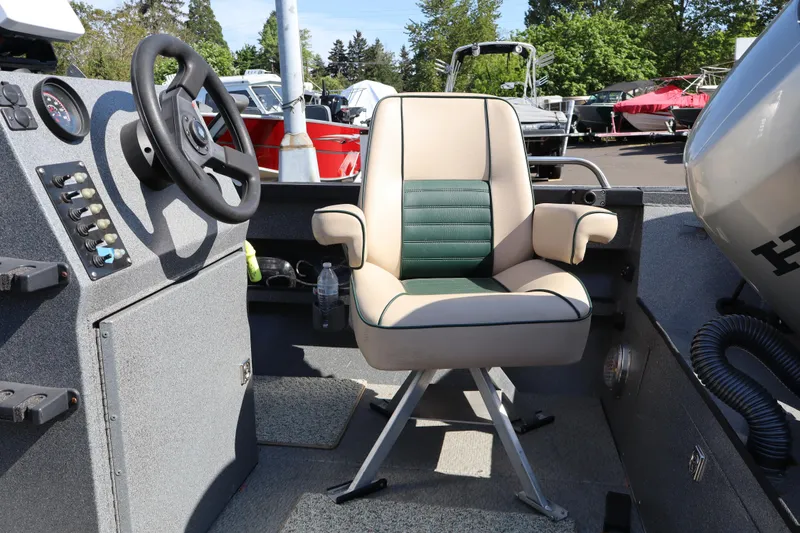 Slide: The Image of 1997 Willie Boats Predator interior with steering wheel and cushioned captain's chair. - 7