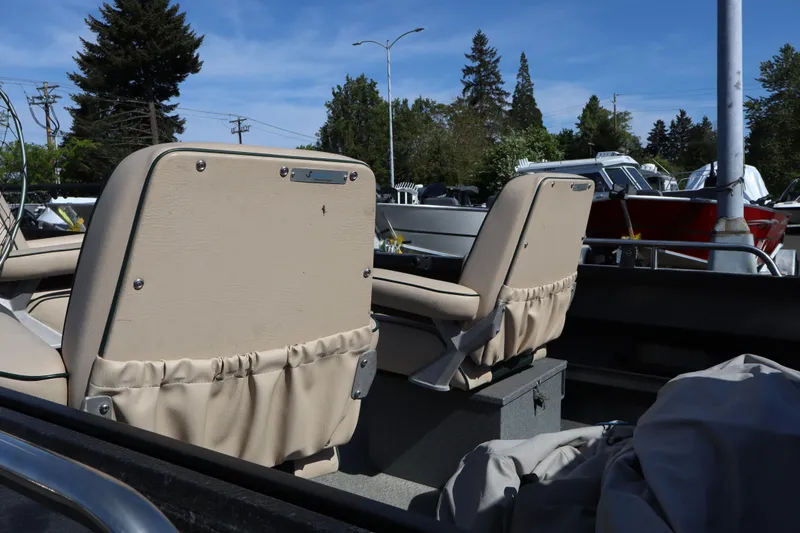 Slide: The Image of 1997 Willie Boats Predator with beige seats, parked outdoors under clear blue sky. - 9