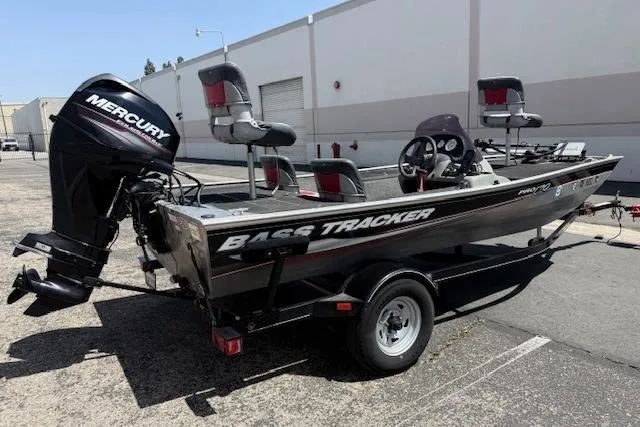 Slide: The Image of 2014 Tracker Pro 170 bass boat with Mercury engine, parked outdoors. - 11