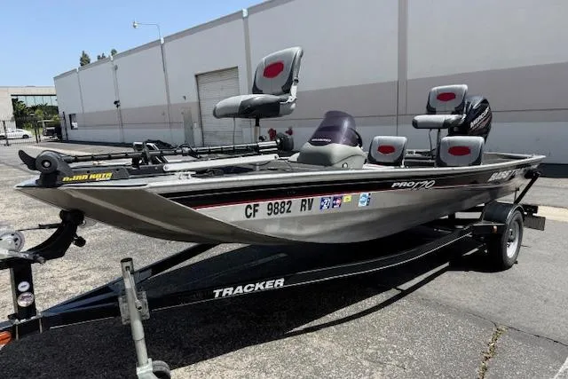 Slide: The Image of 2014 Tracker Pro 170 fishing boat on trailer, parked outdoors. - 2