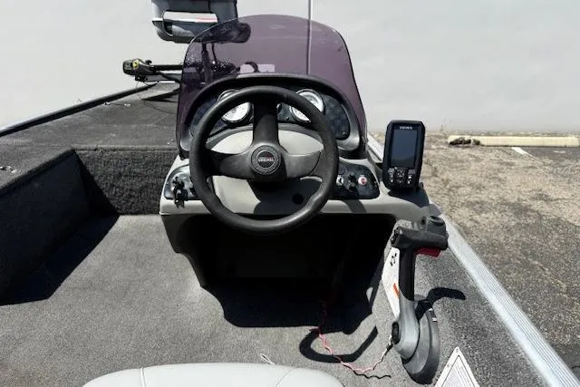 Slide: The Image of 2014 Tracker Pro 170 boat cockpit with steering wheel and navigation equipment. - 23