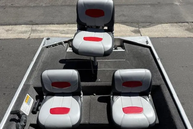 Slide: The Image of 2014 Tracker Pro 170 boat seats with red and gray upholstery, arranged in a fishing setup. - 8