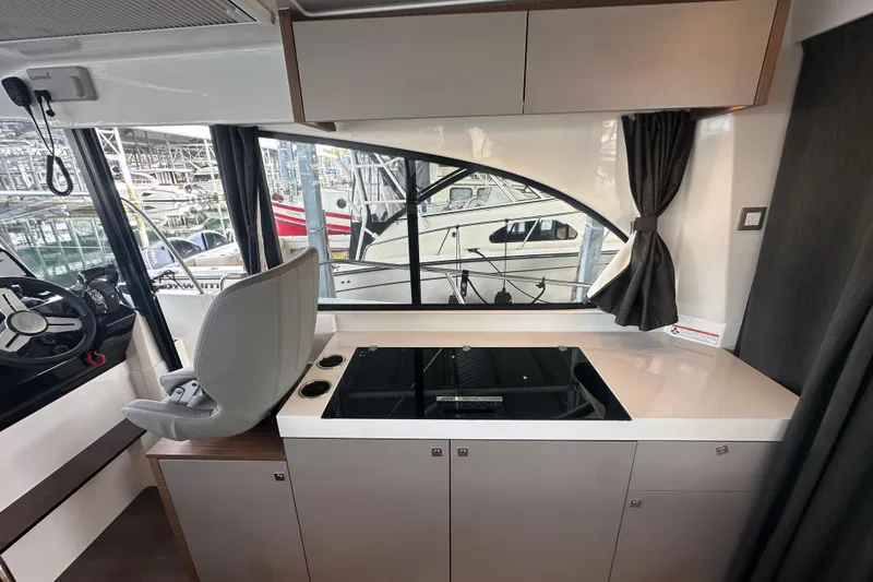 Slide: The Image of Interior of 2023 Beneteau Antares 11 Coupe with modern kitchen and helm station. - 10