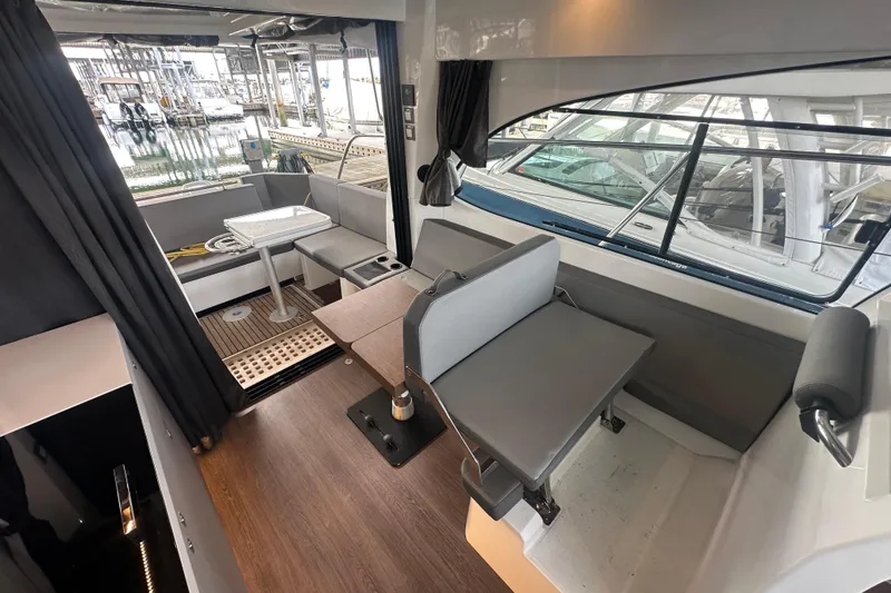 Slide: The Image of Interior of 2023 Beneteau Antares 11 Coupe, featuring modern seating and dining area. - 14
