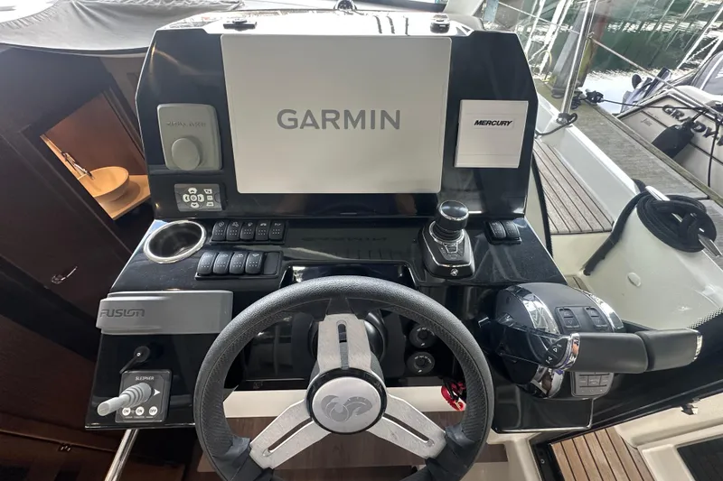 Slide: The Image of Helm of 2023 Beneteau Antares 11 Coupe with Garmin navigation and Mercury controls. - 16