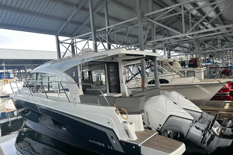 Slide: The Image of 2023 Beneteau Antares 11 Coupe docked in a covered marina. - 3