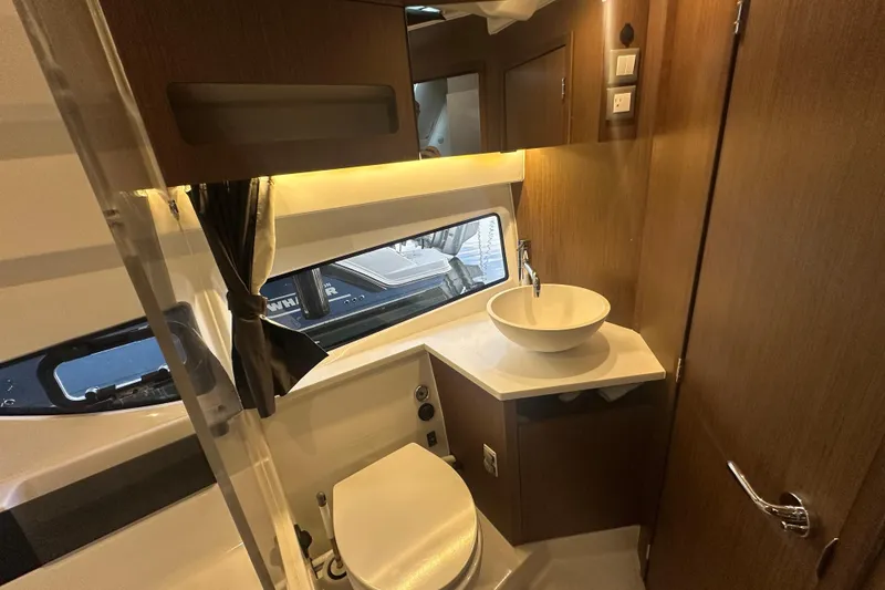 Slide: The Image of Interior of 2023 Beneteau Antares 11 Coupe bathroom with modern sink and wooden accents. - 30