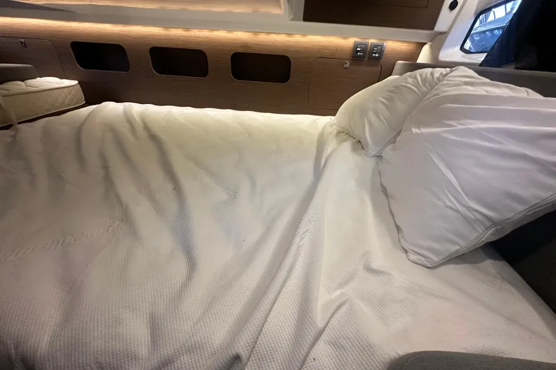 Slide: The Image of Luxurious cabin interior of 2023 Beneteau Antares 11 Coupe with cozy bedding. - 33
