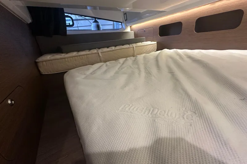 Slide: The Image of Interior cabin of 2023 Beneteau Antares 11 Coupe with plush bedding and modern design. - 34