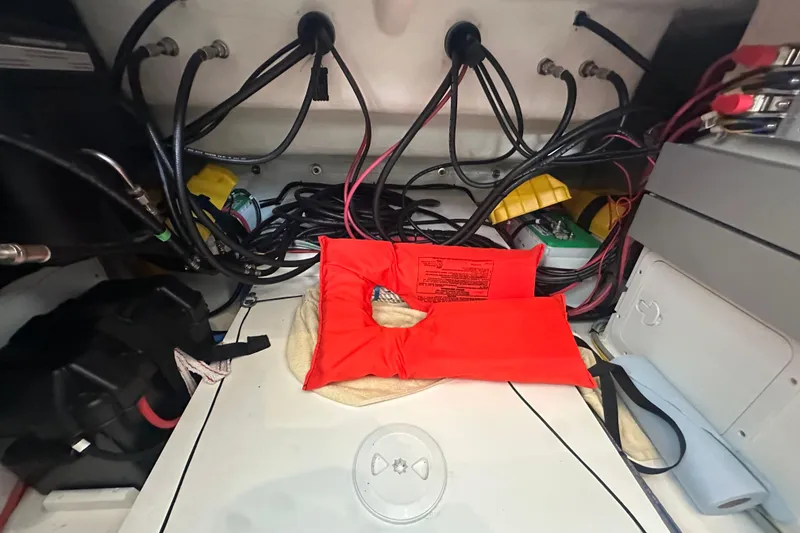 Slide: The Image of Engine compartment of 2023 Beneteau Antares 11 Coupe with wiring and safety equipment. - 35