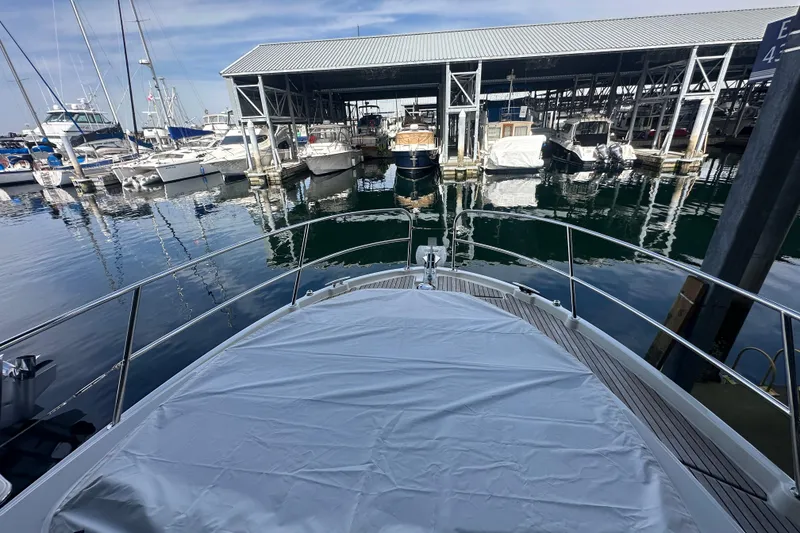 Slide: The Image of 2023 Beneteau Antares 11 Coupe docked at a marina with covered deck. - 42