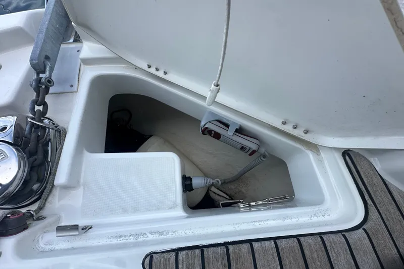 Slide: The Image of Storage compartment on 2023 Beneteau Antares 11 Coupe boat, featuring anchor and equipment. - 43