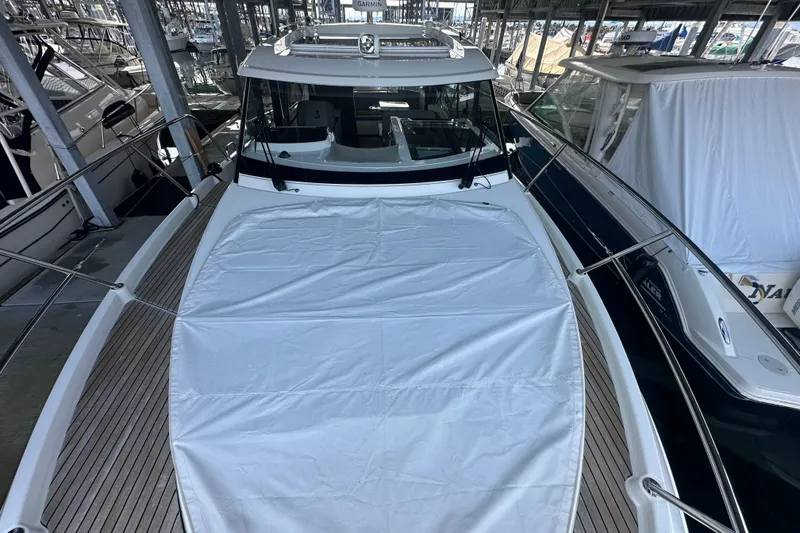 Slide: The Image of 2023 Beneteau Antares 11 Coupe docked, featuring sleek design and spacious deck. - 44
